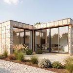 Maison contemporaine à ossature modulaire, construite avec des blocs de plastique recyclé visibles, une isolation extérieure apparente, de grandes baies vitrées orientées au sud et un jardin minimaliste baigné de lumière naturelle.